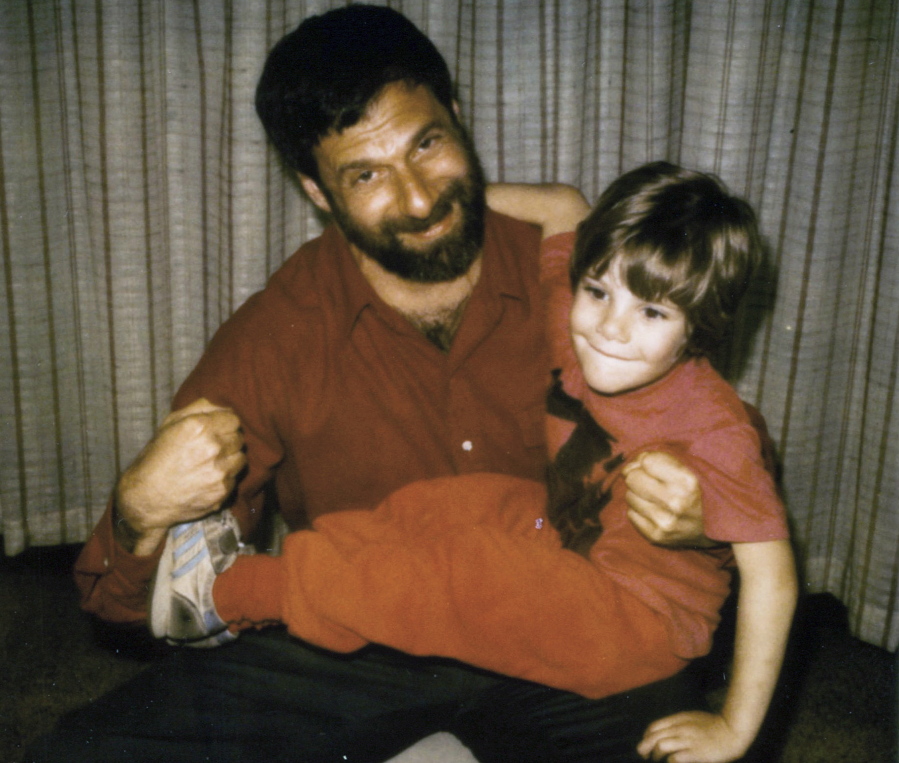 In this May 1985, photo provided by Chesa Boudin, Boudin&#039;s father, David Gilbert, makes fists as his father holds him during a prison visit at Auburn Correctional Facility in Auburn, N.Y. Gilbert, now 76, was convicted of felony murder in the Oct. 20, 1981 robbery of $1.6 million from an armored Brink&#039;s truck at the Nanuet Mall north of New York City that resulted in the deaths of three people. Boudin, now San Francisco&#039;s District Attorney, and others are lobbying New York Gov. Andrew Cuomo for clemency for Gilbert, one of the oldest and longest held inmates in New York state.