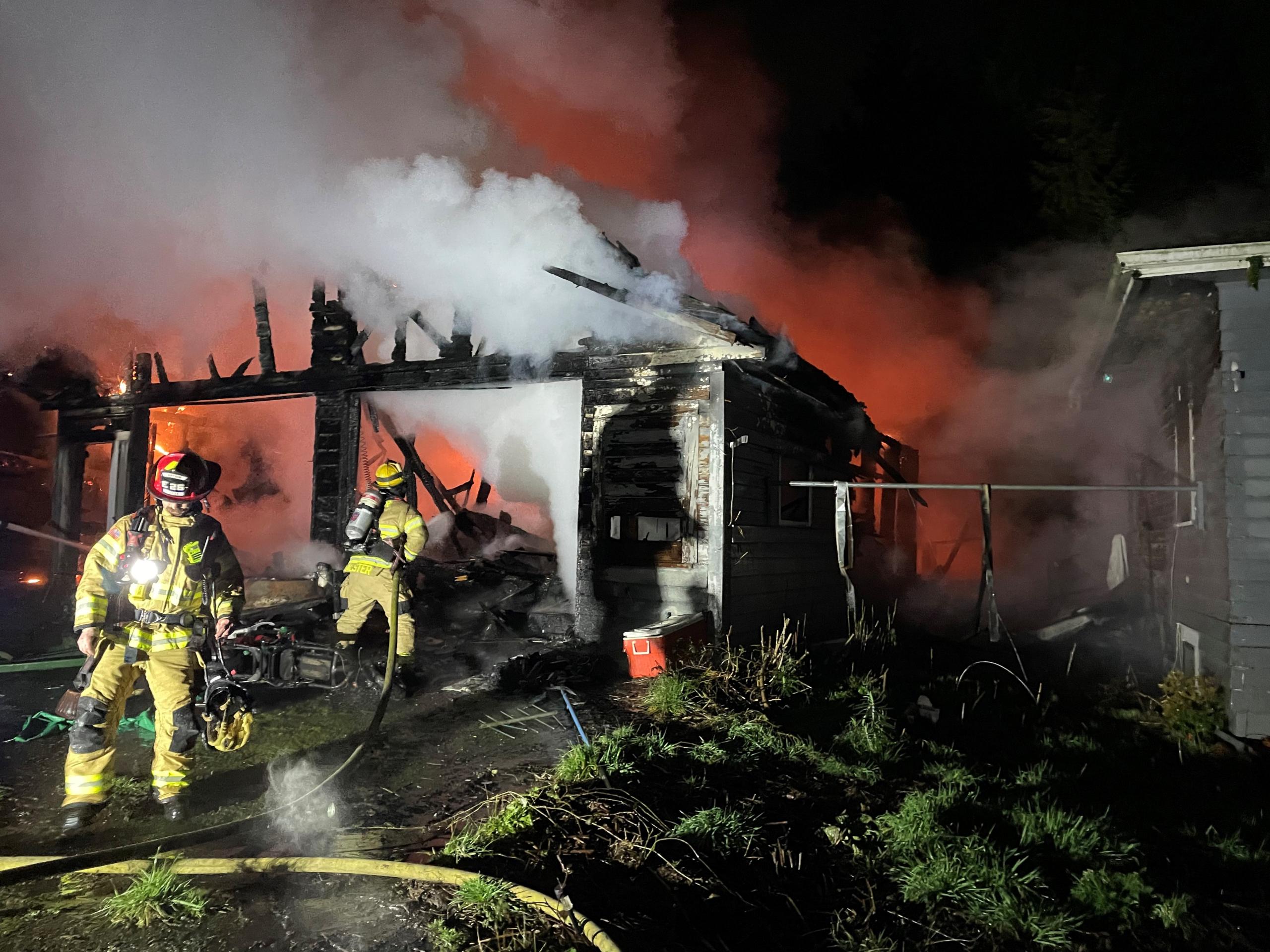 Crews from Clark-Cowlitz Fire Rescue battle a fire that damaged a detached garage and house at 2834 N. Smythe Road in Ridgefield late Monday night.