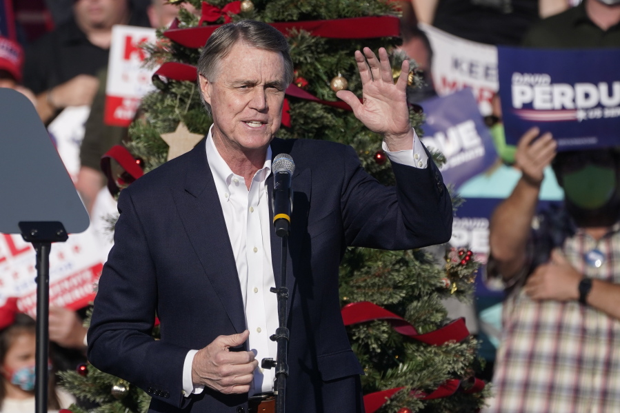 FILE - In this Dec. 10, 2020 file photo, Sen. David Perdue, R-Ga., speaks during a &quot;Save the Majority&quot; rally in Augusta, Ga.  Perdue says he won&#039;t run in 2022 to reclaim a seat in the U.S. Senate. The announcement came Tuesday, Feb. 23, 2021, eight days after the defeated Republican filed campaign paperwork that could have opened the way for him to run against Democratic Sen.