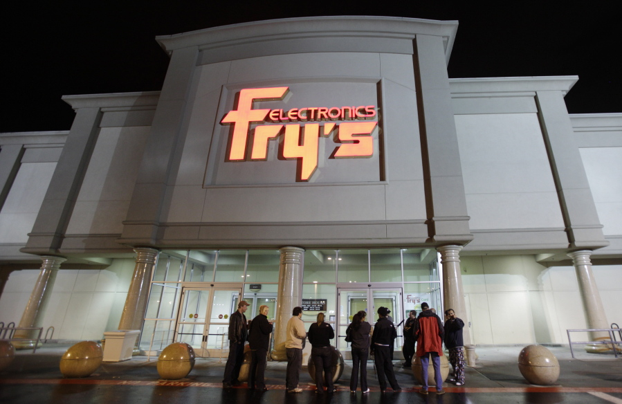 FILE- In this Oct. 21, 2009 file photo, a small crowd begins to gather outside a Fry&#039;s Electronics store in Renton, Wash. The electronics chain is permanently closing, citing the struggles it faced as a retailer during the coronavirus pandemic. The company, which was in business for 36 years, had 31 stores in nine states. Fry&#039;s Electronics Inc. said it stopped regular operations and began the wind-down process of its business on Wednesday, Feb. 24, 2021. (AP Photo/Ted S.