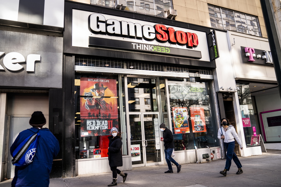 FILE - Pedestrians pass a GameStop store on 14th Street at Union Square, Thursday, Jan. 28, 2021, in the Manhattan borough of New York.  The GameStop saga has been portrayed as a victory of the little guy over Wall Street giants but not everyone agrees, including some lawmakers in Washington.  The House Financial Services Committee is ready to dig into the confounding episode at a hearing on Thursday, Feb. 18.