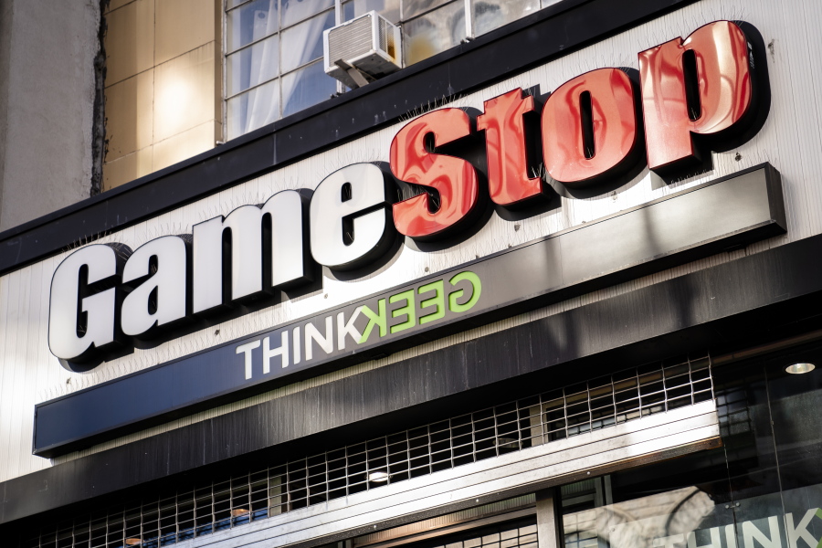 Pedestrians pass a GameStop store Thursday in the Manhattan borough of New York. GameStop stock had rocketed from below $20 to more than $400 this month as a volunteer army of investors on social media challenged big institutions who has placed market bets that the stock would fall.