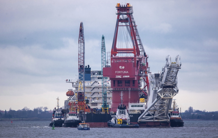 Tugboats get into position on the Russian pipe-laying vessel &quot;Fortuna&quot; in the port of Wismar, Germany, Thursday, Jan 14, 2021. The special vessel is being used for construction work on the German-Russian Nord Stream 2 gas pipeline in the Baltic Sea.
