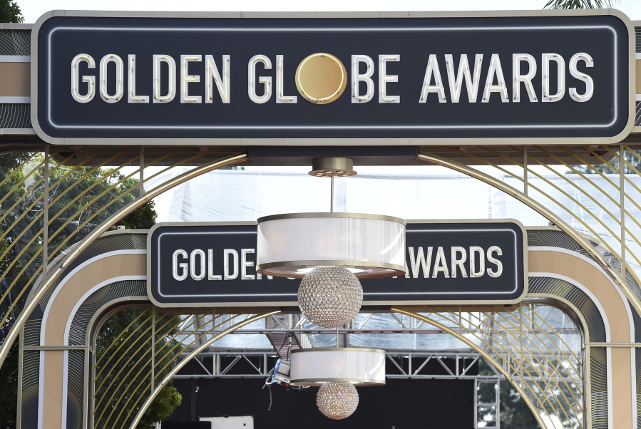 FILE - Event signage appears above the red carpet at the 77th annual Golden Globe Awards, on Jan. 5, 2020, in Beverly Hills, Calif. The 78th annual Golden Globes will be held on Sunday, Feb. 18, 2021.