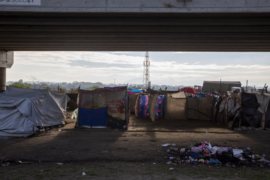 People who lost their homes in last year&#039;s hurricanes Eta and Iota live under tarps they set up under a bridge on the outskirts of San Pedro Sula, Honduras, Monday, Jan. 11, 2021. President Joe Biden has promised investment in Central America to get at the root causes of immigration, but no one expects to see any change soon.