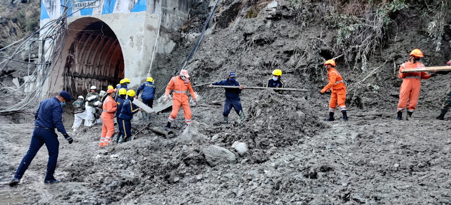 This photograph provided by National Disaster Response Force shows NDRF personnel prepare to rescue workers at one of the hydropower project at Reni village in Chamoli district of Indian state of Uttrakhund, Monday, Feb. 8, 2021. Rescue efforts continued on Monday to save 37 people after part of a glacier broke off, releasing a torrent of water and debris that slammed into two hydroelectric plants on Sunday.