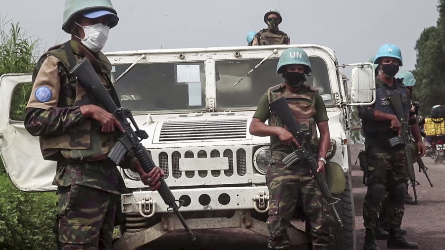 In this image taken from video, United Nations peacekeepers guard the area where a U.N. convoy was attacked and the Italian ambassador to Congo killed, in Nyiragongo, North Kivu province, Congo Monday, Feb. 22, 2021. The Italian ambassador to Congo Luca Attanasio, an Italian carabineri police officer and their Congolese driver were killed Monday in an attack on a U.N. convoy in an area that is home to myriad rebel groups, the Foreign Ministry and local people said.