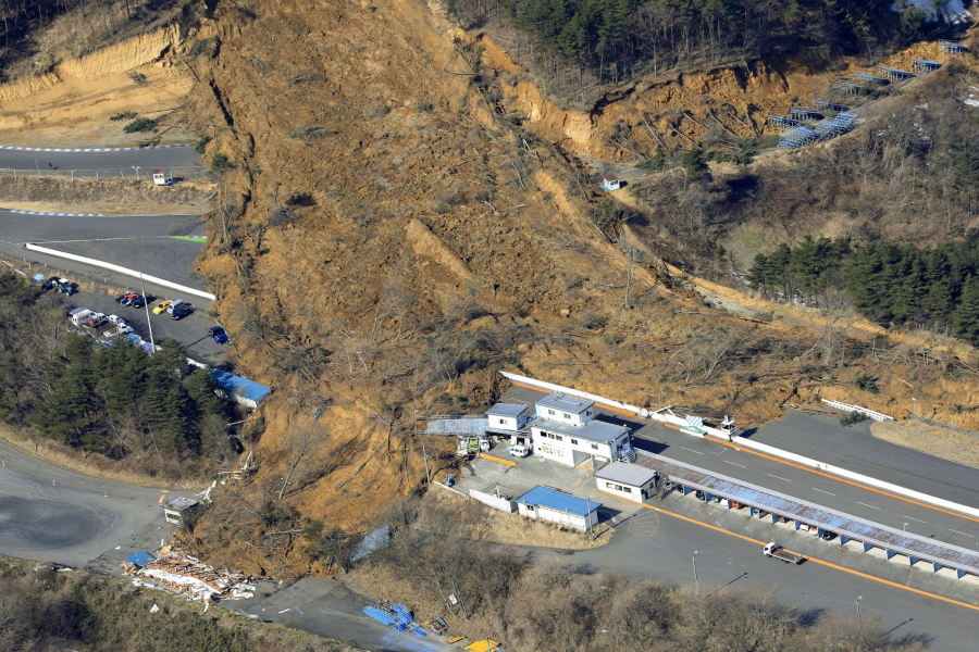 A landslide caused by a strong earthquake covers a circuit course in Nihonmatsu city, Fukushima prefecture, northeastern Japan, Sunday, Feb. 14, 2021. The strong earthquake shook the quake-prone areas of Fukushima and Miyagi prefectures late Saturday, setting off landslides and causing power blackouts for thousands of people.