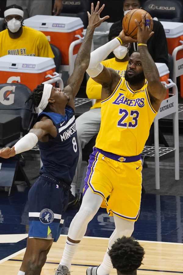 Los Angeles Lakers&#039; LeBron James (23) shoots as Minnesota Timberwolves&#039; Jarred Vanderbilt (8) defends in the first half of an NBA basketball game, Tuesday, Feb. 16, 2021, in Minneapolis.