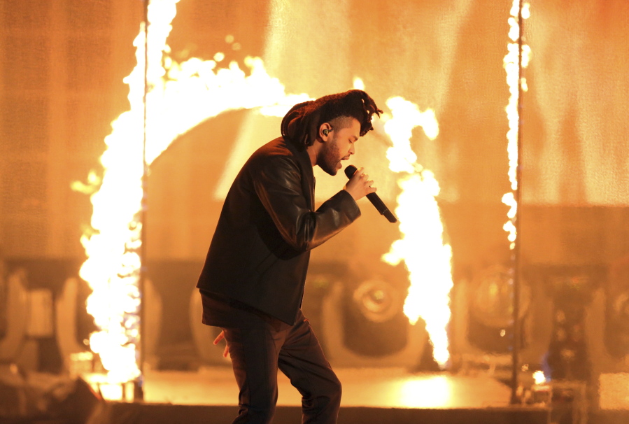 FILE - In this Sunday, Nov. 22, 2015, file photo, the Weeknd performs at the American Music Awards at the Microsoft Theater in Los Angeles. The Weeknd had the No. 1 song of 2020 but &quot;Blinding Lights&quot; was not nominated for a Grammy Award.