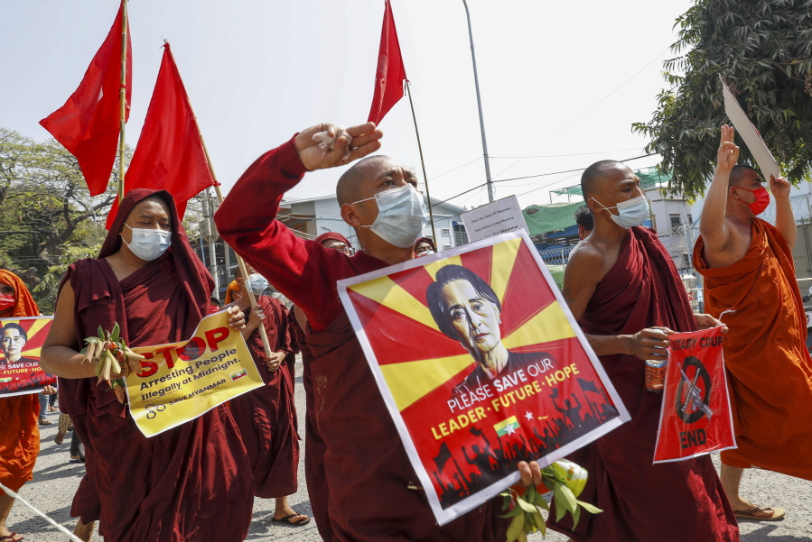 Buddhist monks and nuns display pictures of detained Myanmar leader Aung San Suu Kyi during a protest against the military coup in Mandalay, Myanmar on Tuesday, Feb. 16, 2021. Peaceful demonstrations against Myanmar&#039;s military takeover resumed Tuesday, following violence against protesters a day earlier by security forces and after internet access was blocked for a second straight night.