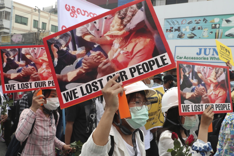 Anti-coup protesters hold an image of Mya Thwet Thwet Khine with a sign that reads &quot;We Lost Our People&quot; during an anti-coup protest rally in Mandalay, Myanmar Saturday, Feb. 20, 2021. Anti-coup protesters in Myanmar&#039;s two largest cities on Saturday paid tribute to the young woman who died a day earlier after being shot by police during a rally against the military takeover.