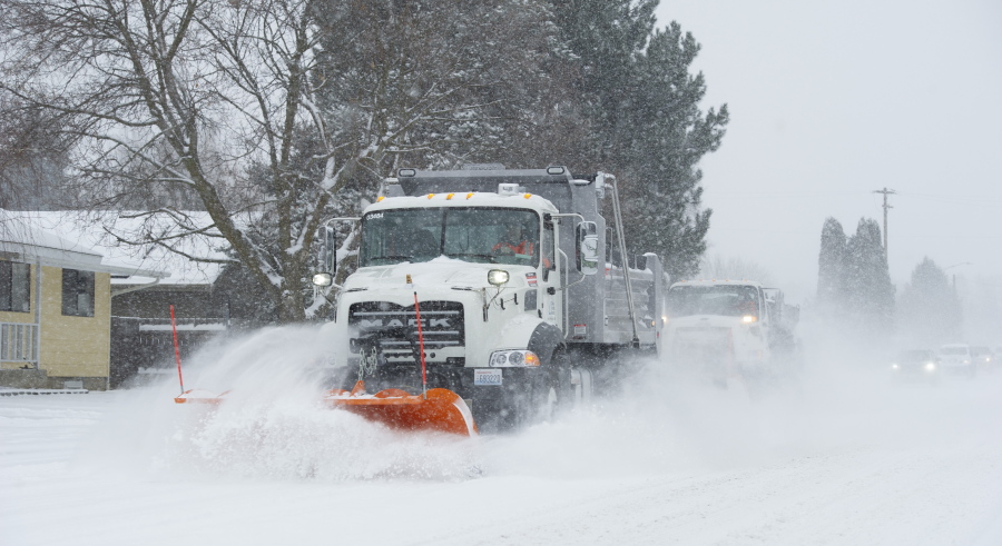 Two Walla Walla City snowplow clears a road of snow in Walla Walla, Wash., Friday, Feb.  12, 2021.  Snow fell throughout Western Washington and parts of Oregon.