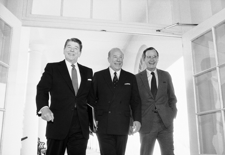 FILE - In this Jan. 9, 1985 file photo, Secretary of State George Shultz, center, walks with President Ronald Reagan and Vice President George Bush upon his arrival at the White House in Washington, after two days of arms talks with the Soviet Union in Geneva. Shultz, former President Reagan&#039;s longtime secretary of state, who spent most of the 1980s trying to improve relations with the Soviet Union and forging a course for peace in the Middle East, died Saturday, Feb. 6, 2021. He was 100.
