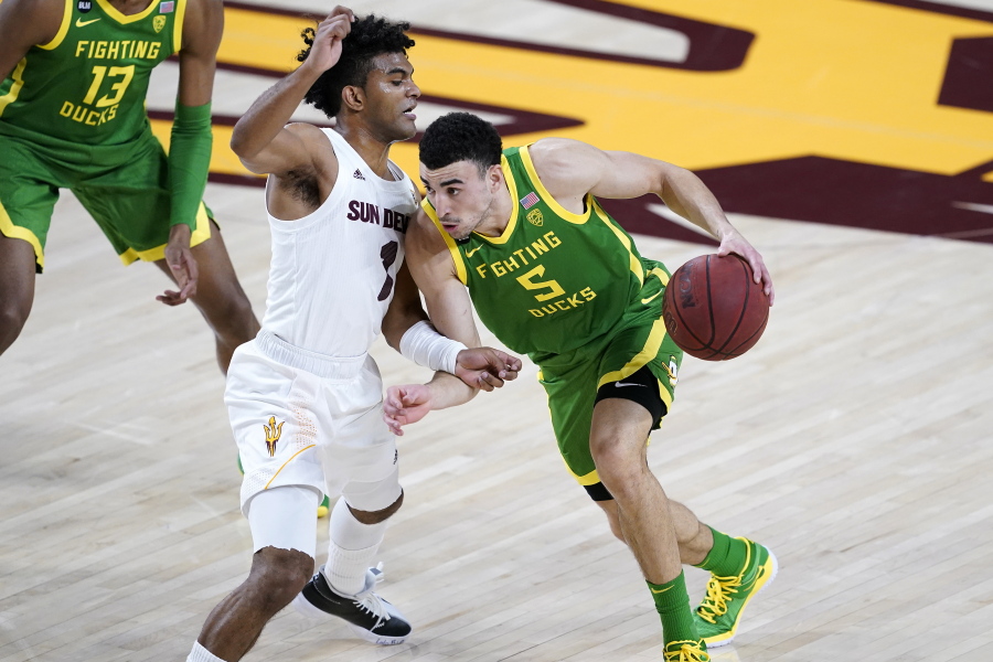 Oregon guard Chris Duarte (5) drives past Arizona State guard Remy Martin (1) during the first half of an NCAA college basketball basketball game, Thursday, Feb. 11, 2021, in Tempe, Ariz.