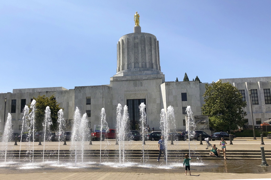 Children play in fountains at the Oregon State Capitol in Salem, Ore., in June 2019.