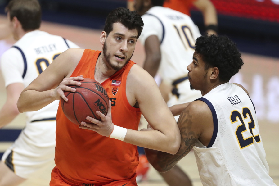 Oregon State center Roman Silva drives to the basket against California forward Andre Kelly during the first half of an NCAA college basketball game in Berkeley, Calif., Thursday, Feb. 25, 2021.