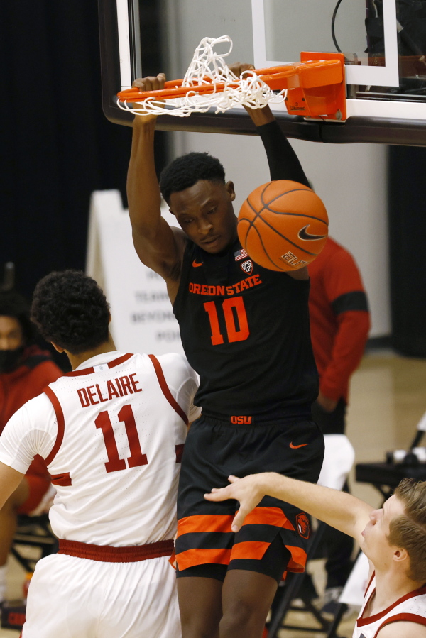 Oregon State forward Warith Alatishe (10) dunks in front of Stanford forward Jaiden Delaire (11) during the first half of an NCAA college basketball game in Stanford, Calif., Saturday, Feb. 27, 2021.