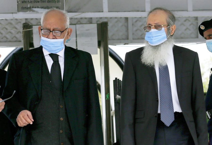 Ahmed Saeed Sheikh, right, father of British-born Pakistani Ahmed Omar Saeed Sheikh, leaves with his lawyer Rauf A. Sheikh, following Daniel Pearl case hearing in the Supreme Court, in Islamabad, Pakistan, Tuesday, Feb. 2, 2021. Pakistan&#039;s Supreme Court on Tuesday ordered the Pakistani-British man acquitted of the 2002 gruesome beheading of American journalist Daniel Pearl off &#039;death row&#039; and moved to a so-called government &#039;safe-house&#039;.