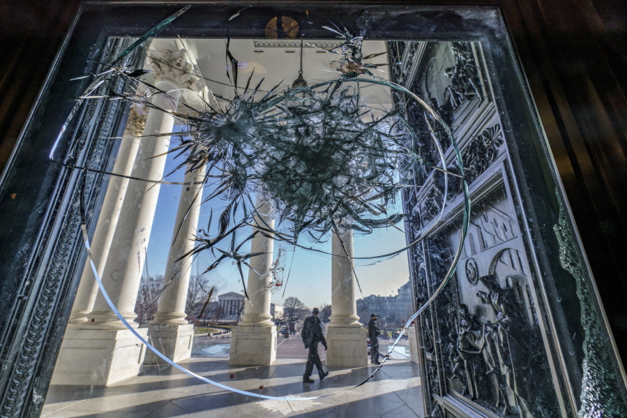 FILE - In this Jan. 12, 2021, file photo, shattered glass from the attack on Congress by a pro-Trump mob is seen in the doors leading to the Capitol Rotunda, in Washington. (AP Photo/J.