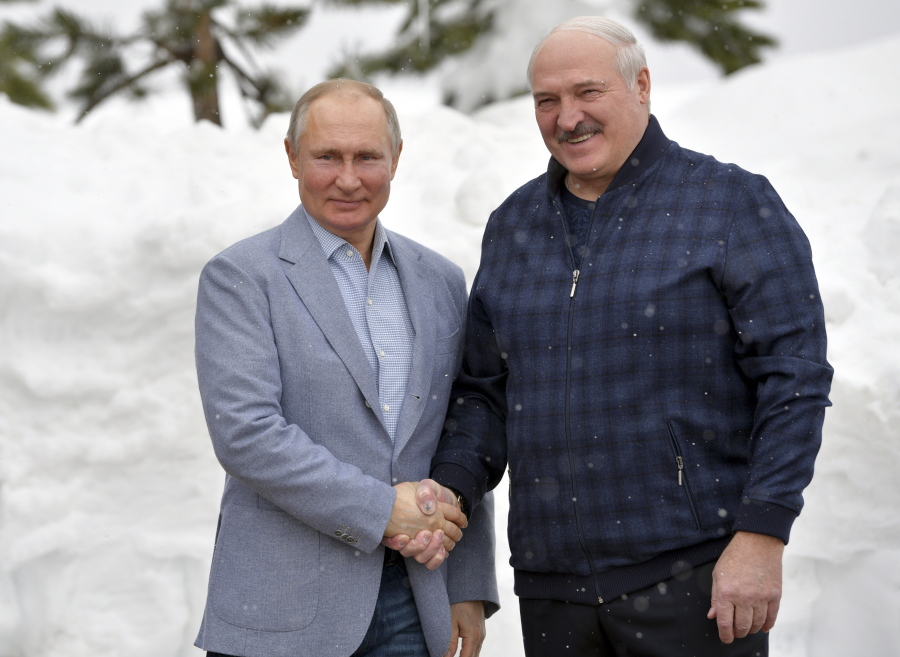 Russian President Vladimir Putin, left, and Belarusian President Alexander Lukashenko pose for a photo during their meeting in the Black Sea resort of Sochi, Russia, Monday, Feb. 22, 2021.