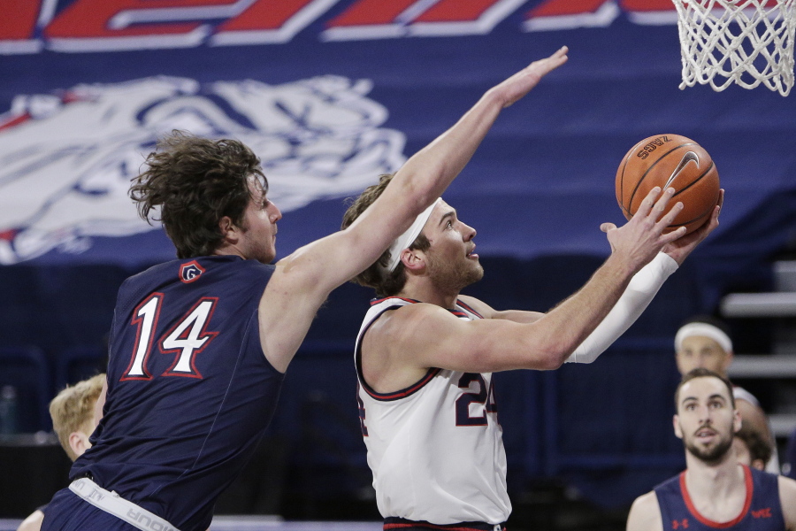 Gonzaga forward Corey Kispert, right, shoots in front of Saint Mary&#039;s forward Kyle Bowen during the first half of an NCAA college basketball game in Spokane, Wash., Thursday, Feb. 18, 2021.