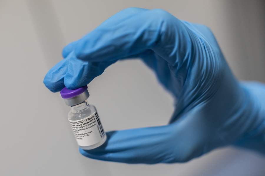 A nurse holds a bottle of the Pfizer-BioNTech COVID-19 vaccine at the Nurse Isabel Zendal Hospital in Madrid, Spain, Monday, Feb. 1, 2021.