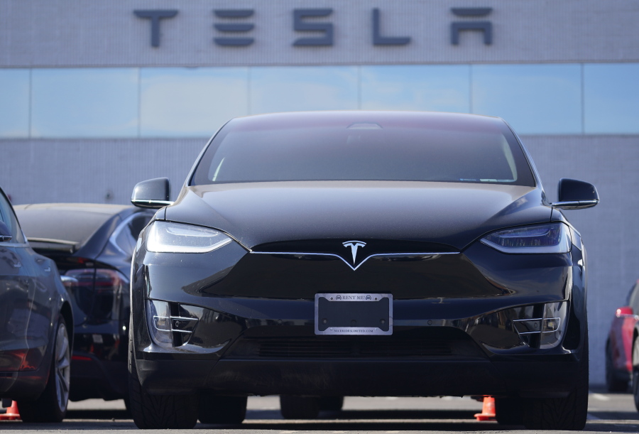 An unsold 2021 Model X sports-utility vehicle sits at a Tesla dealership Sunday, Jan. 24, 2021, in Littleton, Colo. Tesla reports earnings on Wednesday, Jan. 21.