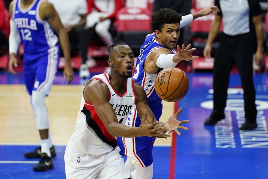 Portland Trail Blazers&#039; Harry Giles III, left, and Philadelphia 76ers&#039; Matisse Thybulle chase after a loose ball during the first half of an NBA basketball game, Thursday, Feb. 4, 2021, in Philadelphia.