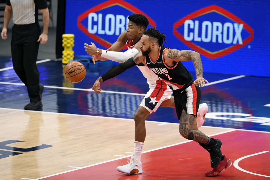 Washington Wizards forward Rui Hachimura, back, of Japan, battles for the ball against Portland Trail Blazers guard Gary Trent Jr. (2) during the first half of an NBA basketball game, Tuesday, Feb. 2, 2021, in Washington.