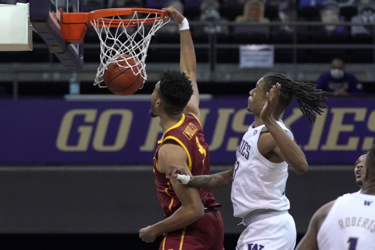Southern California forward Isaiah Mobley dunks next to Washington forward Hameir Wright during the first half of an NCAA college basketball game Thursday, Feb. 11, 2021, in Seattle. (AP Photo/Ted S.