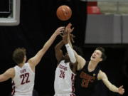 Washington State guards Ryan Rapp (22) and Noah Williams (24) and Southern California guard Drew Peterson (13) go after a rebound during the second half of an NCAA college basketball game in Pullman, Wash., Saturday, Feb. 13, 2021.