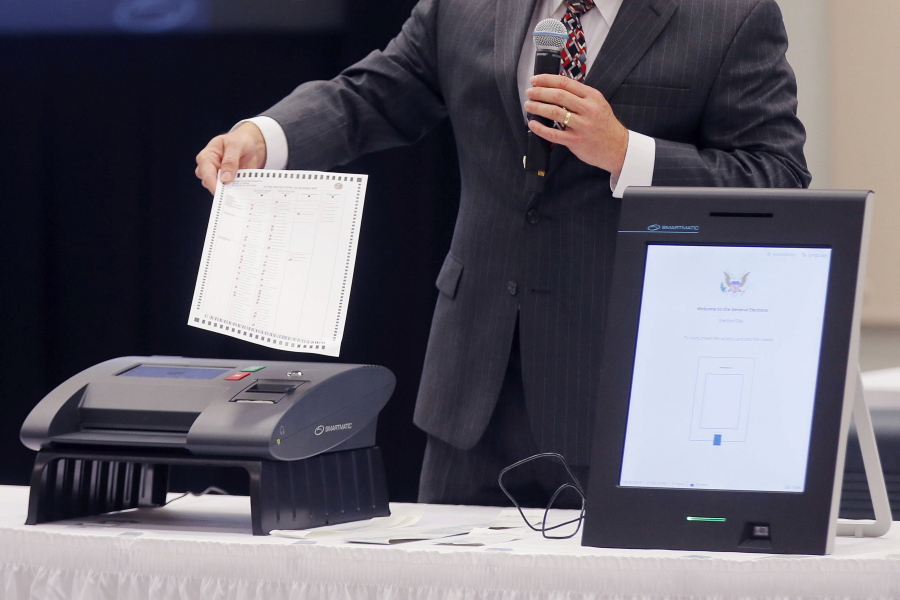 FILE - In this Thursday, Aug. 30, 2018 file photo, a Smartmatic representative demonstrates his company&#039;s system which has scanners and touch screens with printout options at a meeting of the Secure, Accessible &amp; Fair Elections Commission in Grovetown, Ga. Antonio Mugica, CEO of Smartmatic, the electronic voting company being targeted by allies of Donald Trump, said baseless claims that it helped flip the 2020 election for Joe Biden threatens to undermine Americans&#039; faith in democracy and the company is threatening legal action unless Fox News, Rudy Giuliani and other Trump allies fully retract baseless claims.