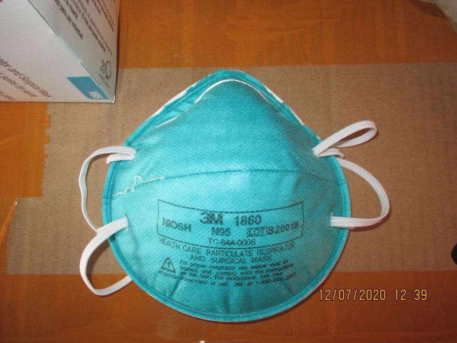 This December 2020 image provided by U.S. Immigration and Customs Enforcement (ICE) shows a counterfeit N95 surgical mask that was seized by ICE and U.S. Customs and Border Protection. Federal investigators are probing a massive counterfeit N95 mask operation sold in at least five states to hospitals, medical facilities, and government agencies and expect the number to rise significantly in coming weeks. The fake 3M masks are at best a copyright violations and at worst unsafe fakes that put unknowing health care workers at grave risk for coronavirus. And they are becoming increasingly difficult to spot.