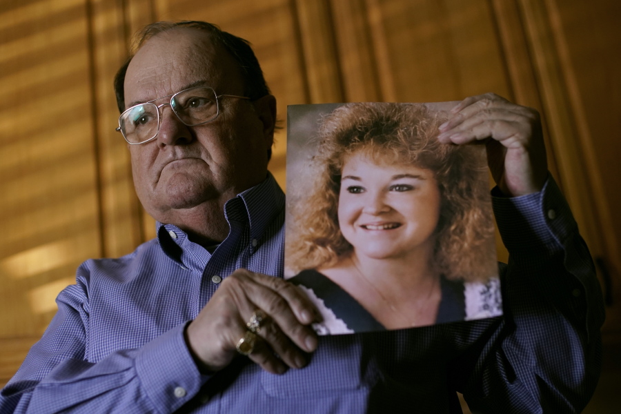 Mortuary owner Brian Simmons holds a photo of his daughter Rhonda Ketchum who died before Christmas of COVID-19, Thursday, Jan. 28, 2021, in Springfield, Mo. Simmons has been making more trips to homes to pick up bodies to be cremated and embalmed since the pandemic hit. For many families, home is a better setting than the terrifying scenario of saying farewell to loved ones behind glass or during video calls amid the coronavirus pandemic.