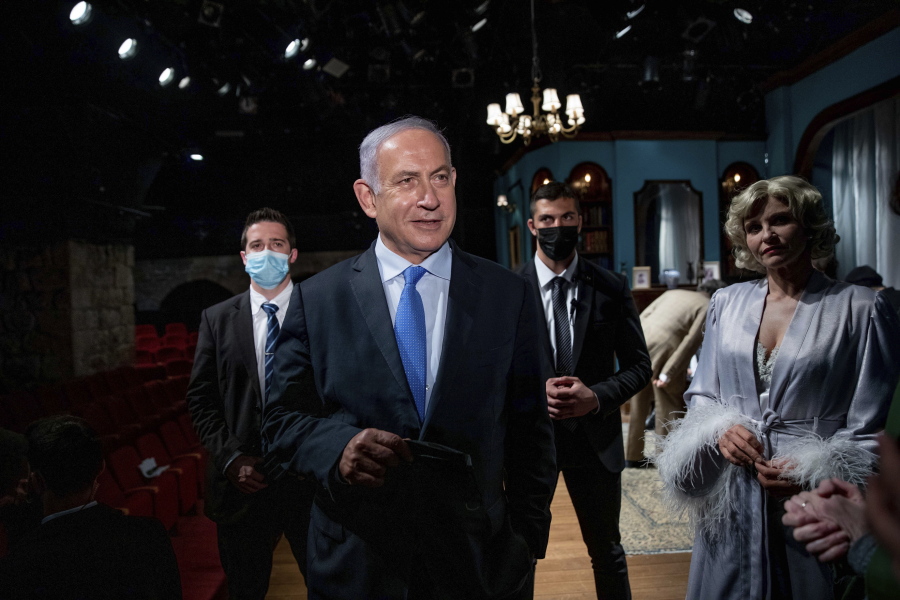 Israeli Prime Minister Benjamin Netanyahu meets Israeli actress Carmit Mesilati Kaplan, right, during a visit to the Khan theater ahead of the re-opening of the culture sector, in Jerusalem on Tuesday, Feb.  23, 2021.