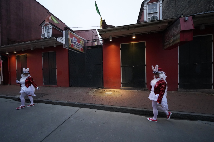 People in costume walk past a shuttered bar on Bourbon Street in the French Quarter of New Orleans, Friday, Feb. 12, 2021. New Orleans&#039; annual pre-Lenten Mardi Gras celebration is muted this year because of the coronavirus pandemic. Parades canceled. Bars closed. Crowds suppressed. Mardi Gras joy is muted this year in New Orleans as authorities seek to stifle the coronavirus&#039;s spread. And it&#039;s a blow to the tradition-bound city&#039;s party-loving soul.