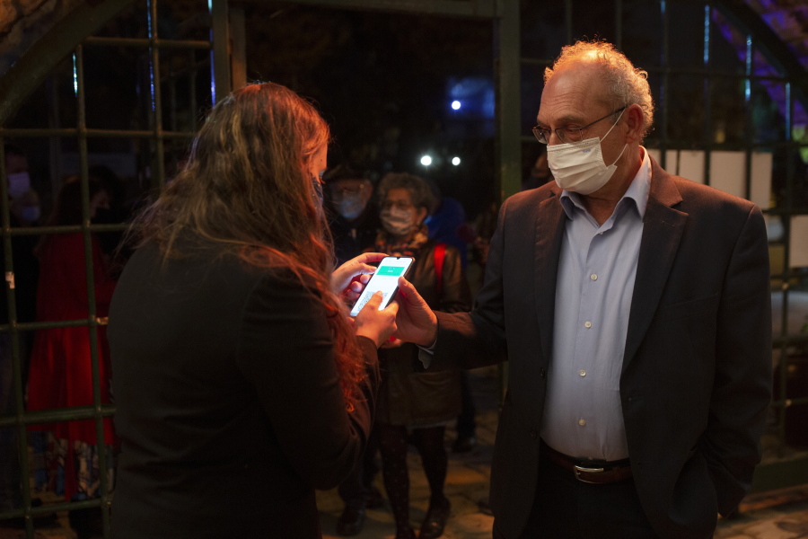 A man presents his &quot;green passport,&quot; proof that he is vaccinated against the coronavirus, on opening night at the Khan Theater for a performance where all guests were required to show proof of vaccination or full recovery from the virus, in Jerusalem, Tuesday, Feb. 23, 2021.