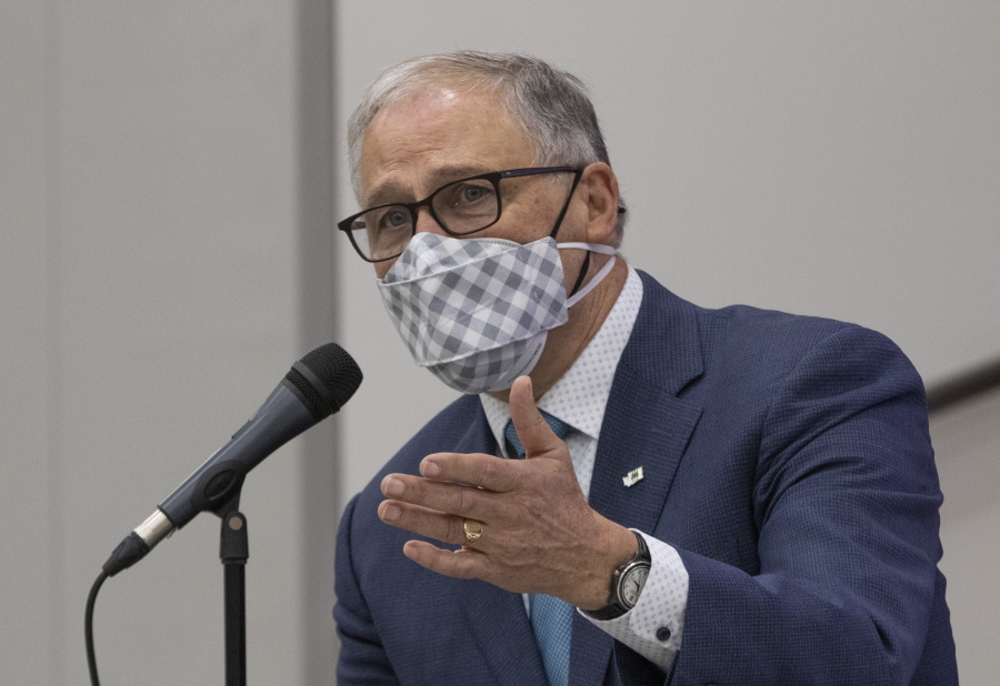 Inslee speaks with administrators and teachers in a question and answer session after visiting two classrooms at Firgrove Elementary School in Puyallup, Wash., Thursday, Feb. 18, 2021. Students are back in school and all teachers and students are wearing masks. (Ellen M.