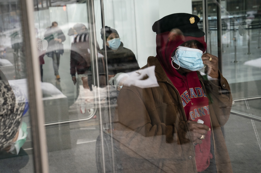 FILE - In this Feb. 3, 2021, file photo, a patient adjusts his face mask as he leaves a COVID-19 vaccination site inside the Jacob K. Javits Convention Center in New York. States are beginning to ease coronavirus restrictions, but health experts say we don&#039;t know enough yet about variants to roll back measures that could help slow their spread.