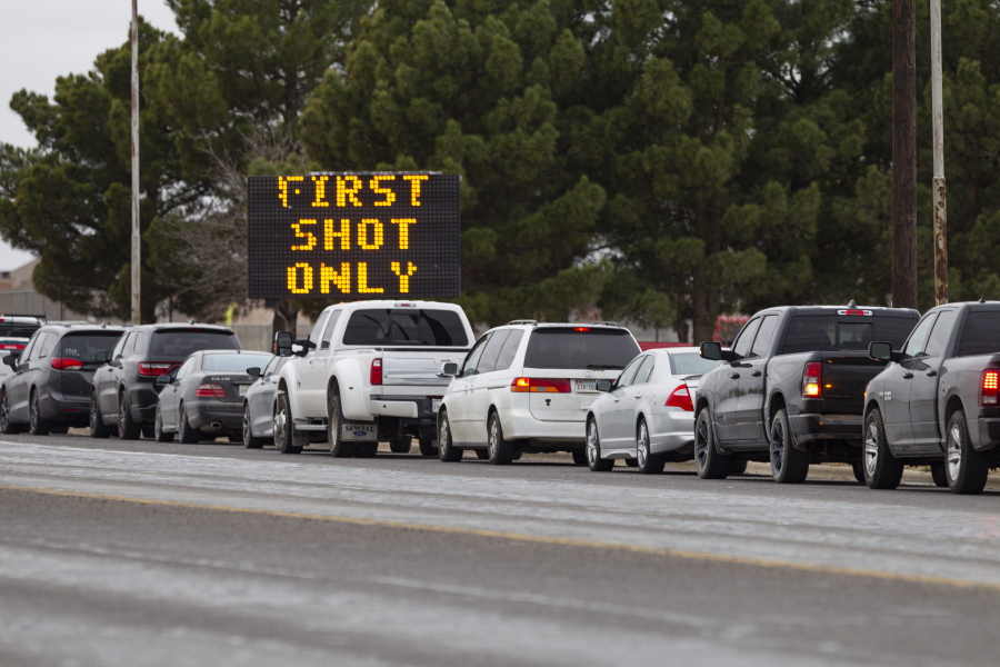 Motorists line up along Yukon Road outside of Ratliff Stadium as they wait to receive the first dose of the Pfizer COVID-19 vaccine at the vaccination clinic held by the City of Odessa and Medical Center Hospital, Thursday, Feb. 25, 2021, in Odessa, Texas.