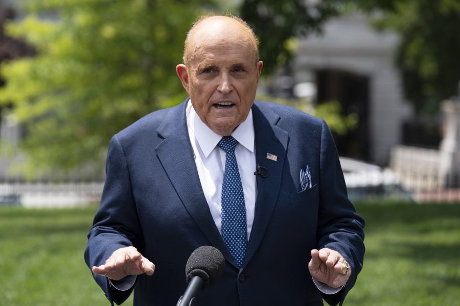 FILE - Rudy Giuliani, a personal attorney for President Donald Trump, talks with reporters outside the White House, Wednesday, July 1, 2020, in Washington. A voting technology company is suing Fox News, three of its top hosts, Giuliani and Sidney Powell for $2.7 billion, charging that the defendants conspired to spread false claims that the company helped steal the U.S. presidential election away from former President Donald Trump.