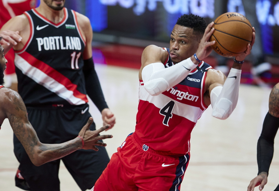 Washington Wizards guard Russell Westbrook looks to pass the ball during the first half of the team&#039;s NBA basketball game against the Portland Trail Blazers in Portland, Ore., Saturday, Feb. 20, 2021.
