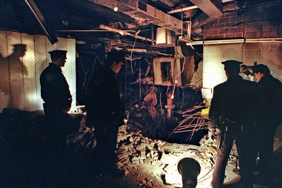 FILE - In this Feb. 27, 1993, file photo, Port Authority and New York City Police officers view the damage caused by a truck bomb that exploded in the garage of New York&#039;s World Trade Center the previous day. Decades after going to prison, some of the men responsible for the World Trade Center bombing that killed six people 28 years ago Friday, Feb. 26, 2021, are still trying to whittle down their onetime life sentences on the remote chance that they could someday be freed.