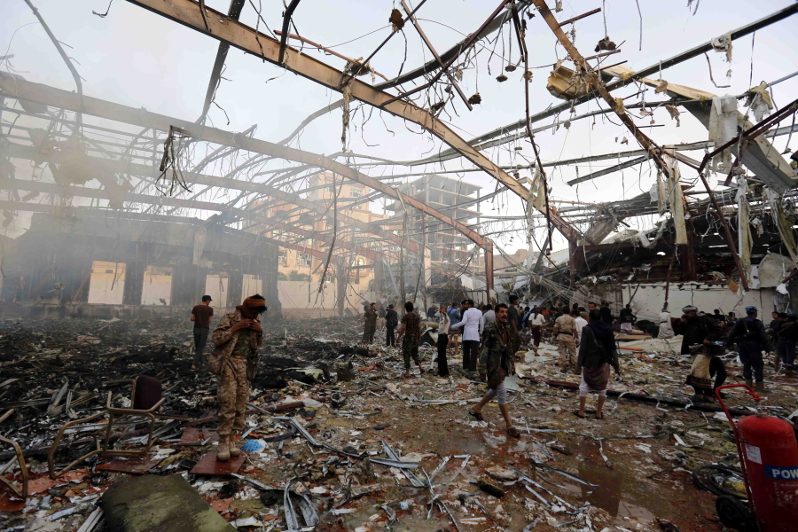 FILE - In this Oct. 8, 2016 file photo, people inspect the aftermath of a Saudi-led coalition airstrike in Sanaa, Yemen.  Yemen&#039;s war began in September 2014, when the Houthis seized the capital Sanaa. Saudi Arabia, along with the United Arab Emirates and other countries, entered the war alongside Yemen&#039;s internationally recognized government in March 2015. The war has killed some 130,000 people and driven the Arab world&#039;s poorest country to the brink of famine.