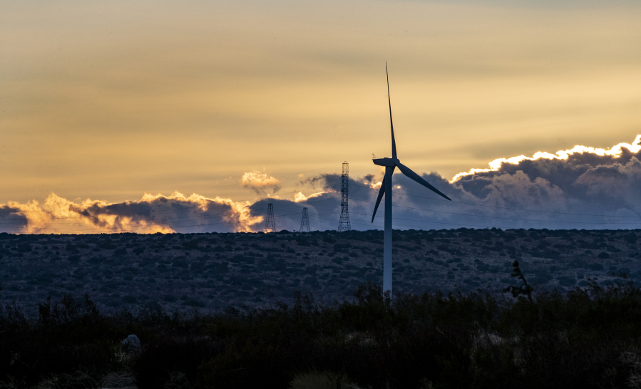 Dusk settles over power-generating wind turbines near the Tehachapi Mountains in Rosamond. Federal wildlife officials are allowing Manzana, a private wind energy company, to provide funding to breed critically endangered California condors to replace any killed by its turbines.
