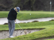 Camas sophomore Eli Huntington hits an approach shot from a tough lie on the fourth hole on Wednesday, February 3, 2021 at Camas Meadows Golf Course.