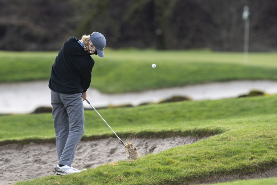 Camas sophomore Eli Huntington hits an approach shot from a tough lie on the fourth hole on Wednesday, February 3, 2021 at Camas Meadows Golf Course.