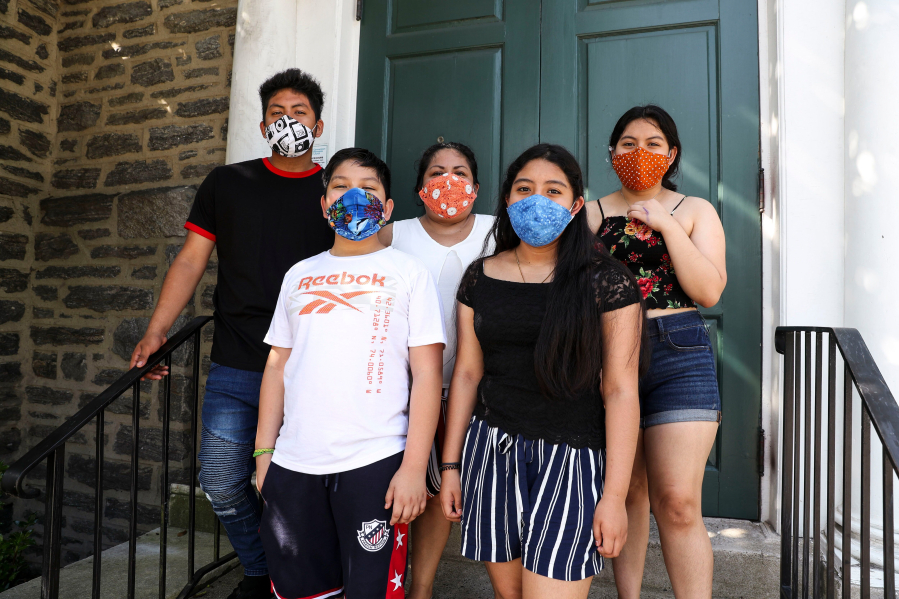 Carmela Apolonio Hernandez, center, is pictured with her four children on the steps of the Germantown Mennonite Church in Pennsylvania, where the family has lived in sanctuary to avoid deportation.