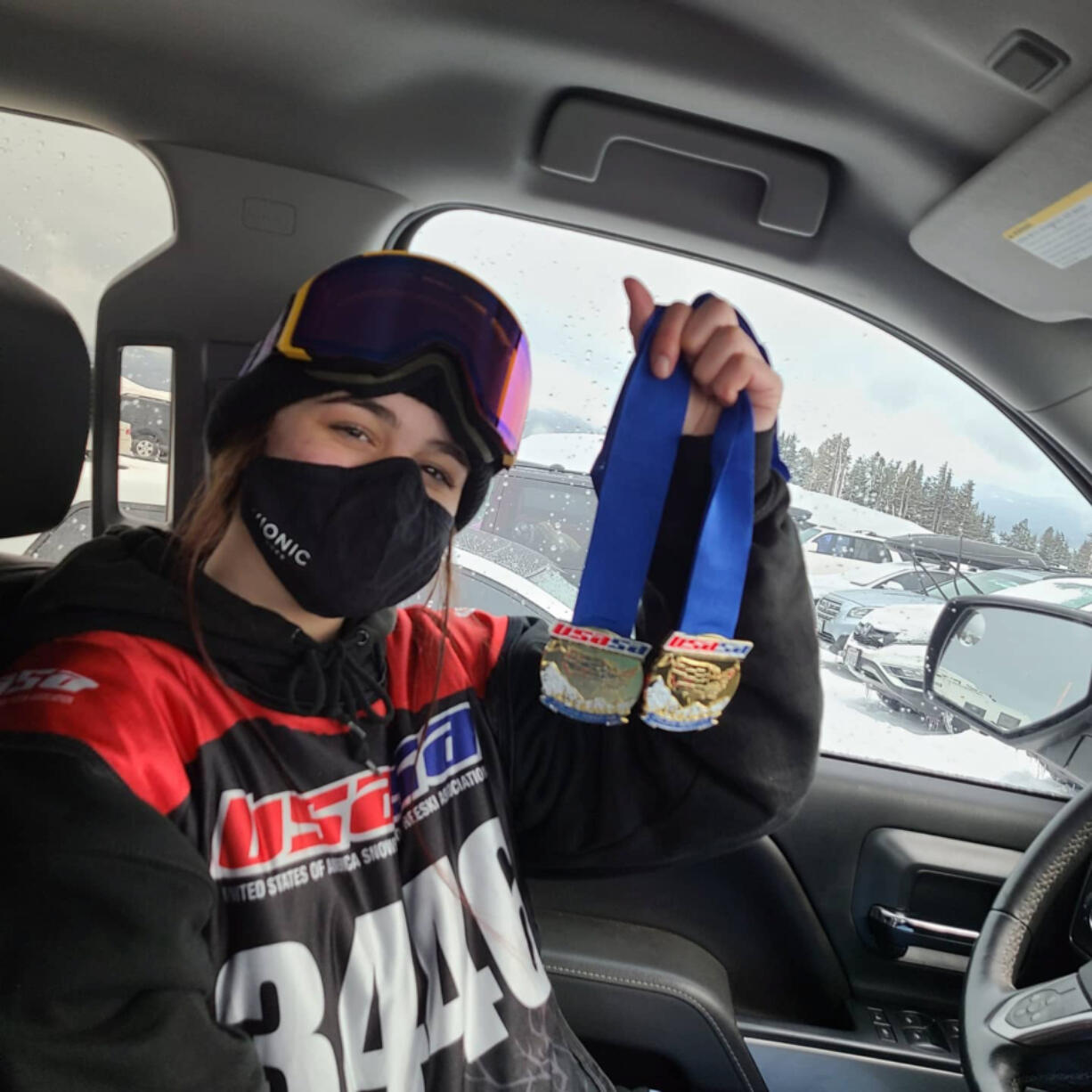 Zoe Smith of Camas holds medals she won on March 7 at a United States of America Snowboard and Freeski Association slopestyle  competition at Timberline on Mount Hood.